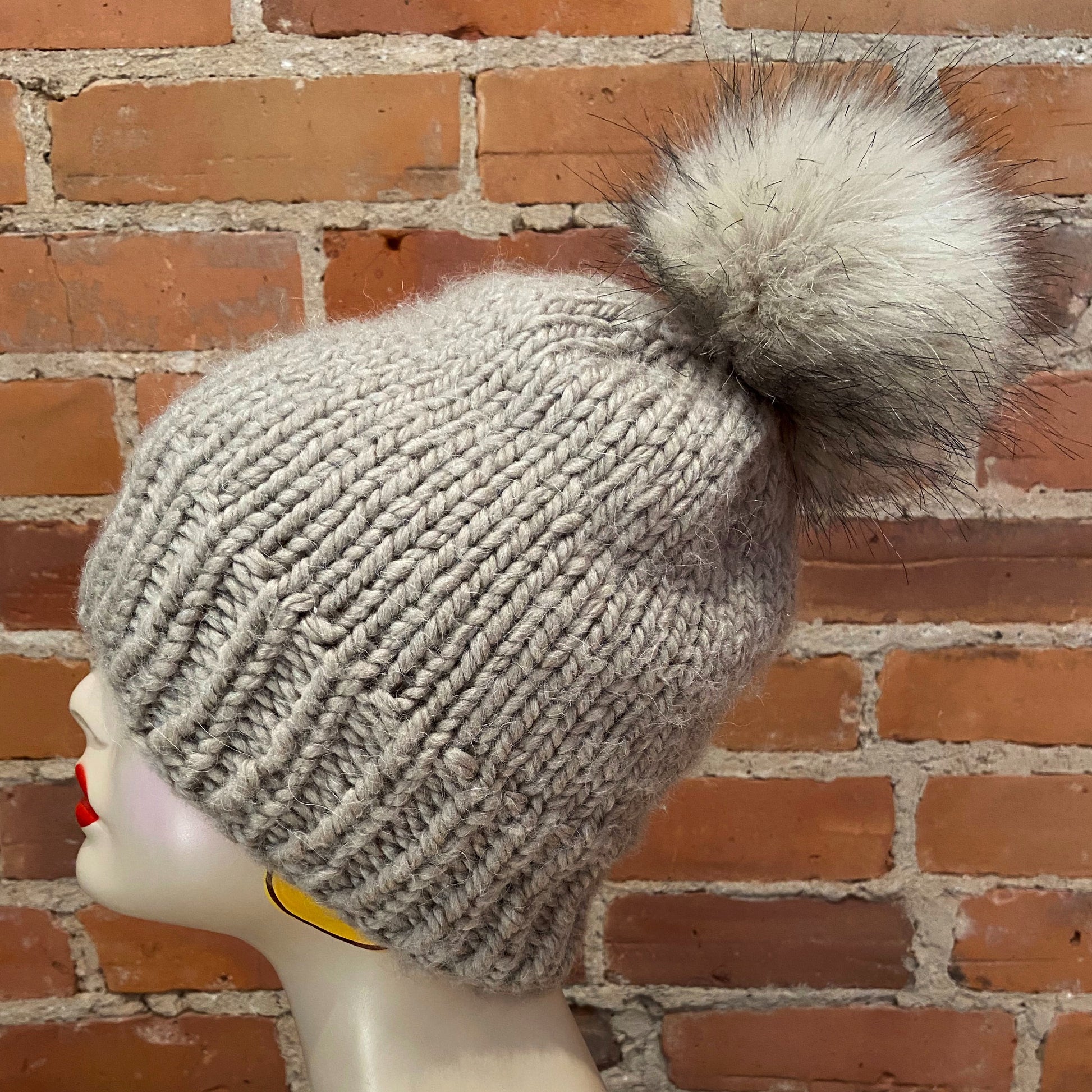 Side View of Beige Fox Faux Fur Pom on Knit Hat
