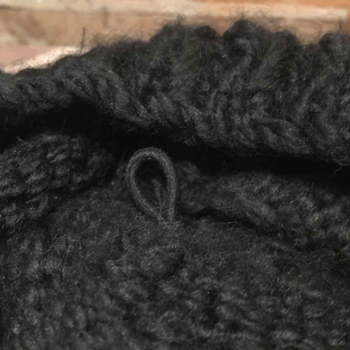 fabric covered loop attached on the insider of a knit hat