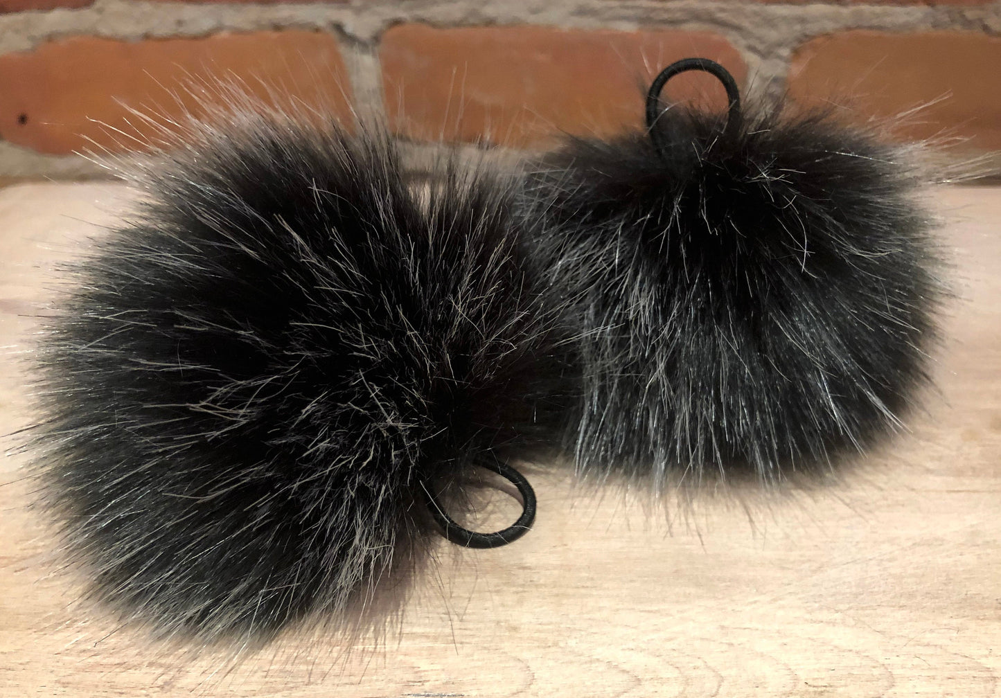 Black Silver Pom Pom, with fabric covered elastic loop attachments
