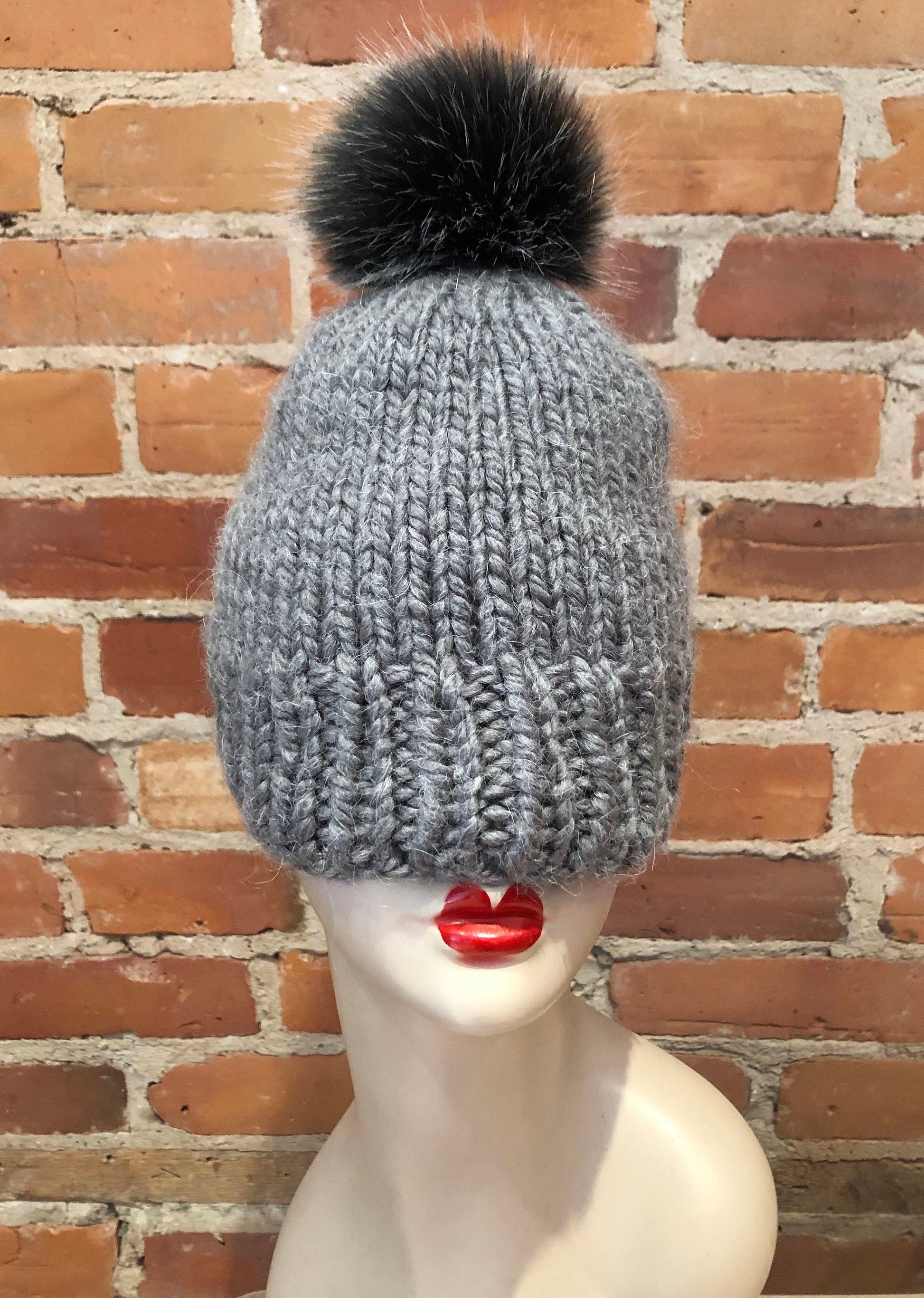 Black Silver Pom Pom on a grey knit hat